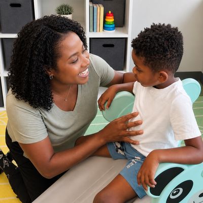 A Therapy Connections therapist smiling with a young boy during a play-based therapy session